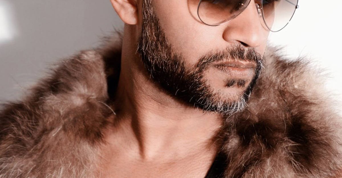 Fashion-forward man wearing a fur coat and sunglasses, exuding style.