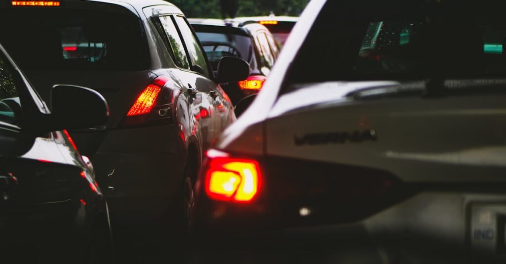 A close-up view of a traffic jam showcasing rear car lights glowing at dusk.