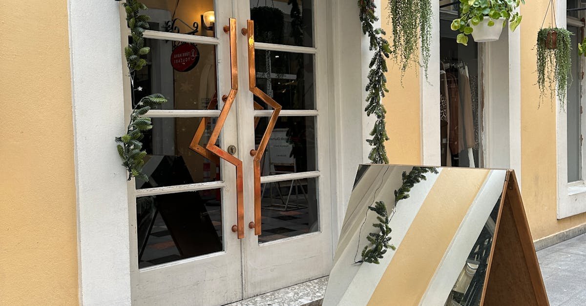 Stylish storefront with hanging plants and a prominent sign enhances urban charm.