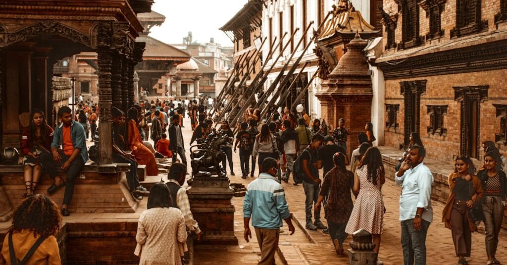 Vibrant street scene in Kathmandu, Nepal showcasing historical architecture and a diverse crowd.