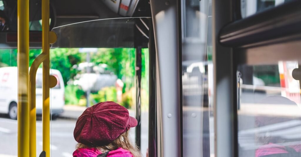 A woman wearing a pink outfit sits on a city bus in Trento, Italy, capturing urban commuting life.