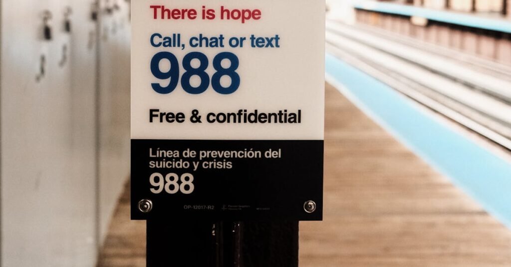 A sign for suicide and crisis support on a train platform, offering free and confidential help.