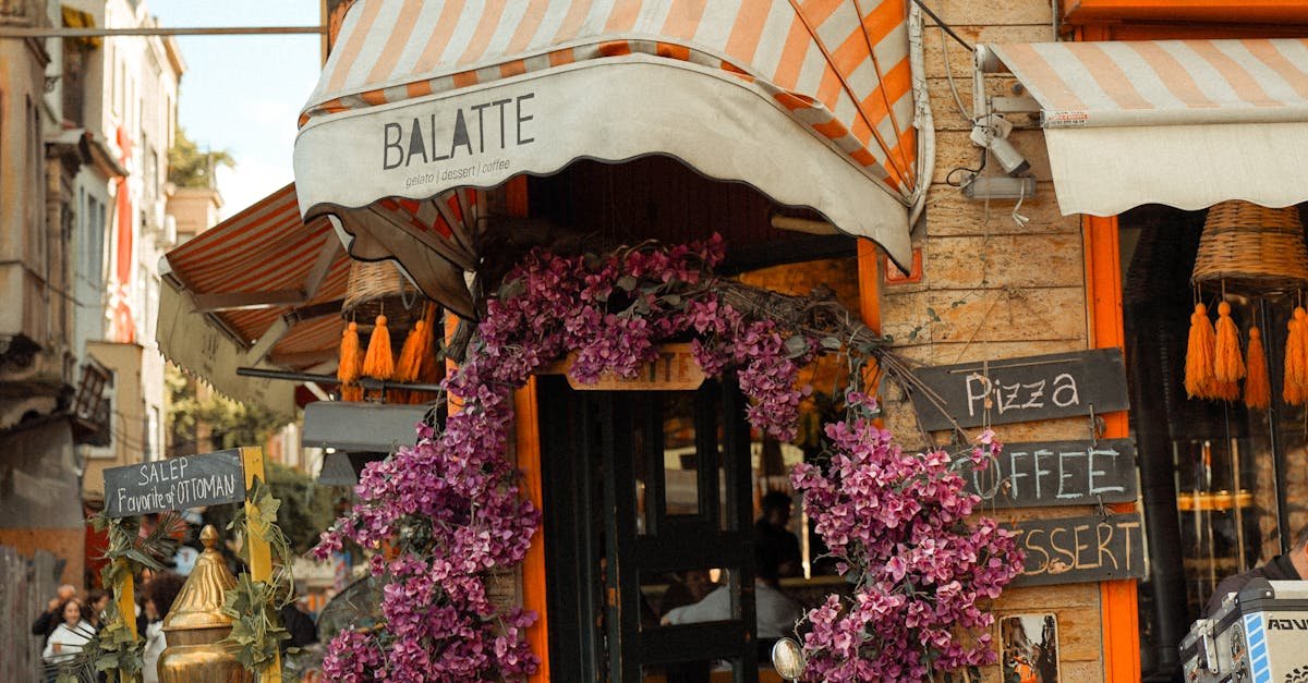 A vibrant café in Istanbul's Balat district with a classic Vespa parked outside, adorned with blooming flowers.