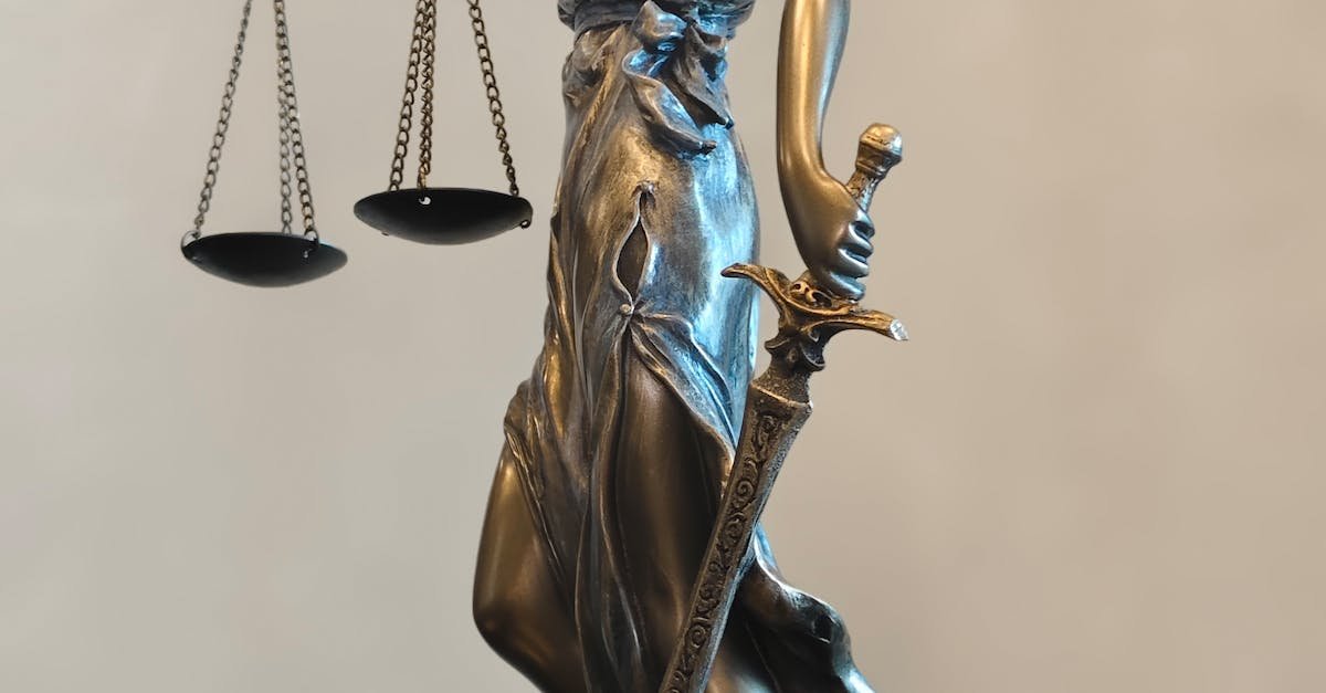 A detailed statue of Lady Justice holding scales and a sword, symbolizing law and fairness.
