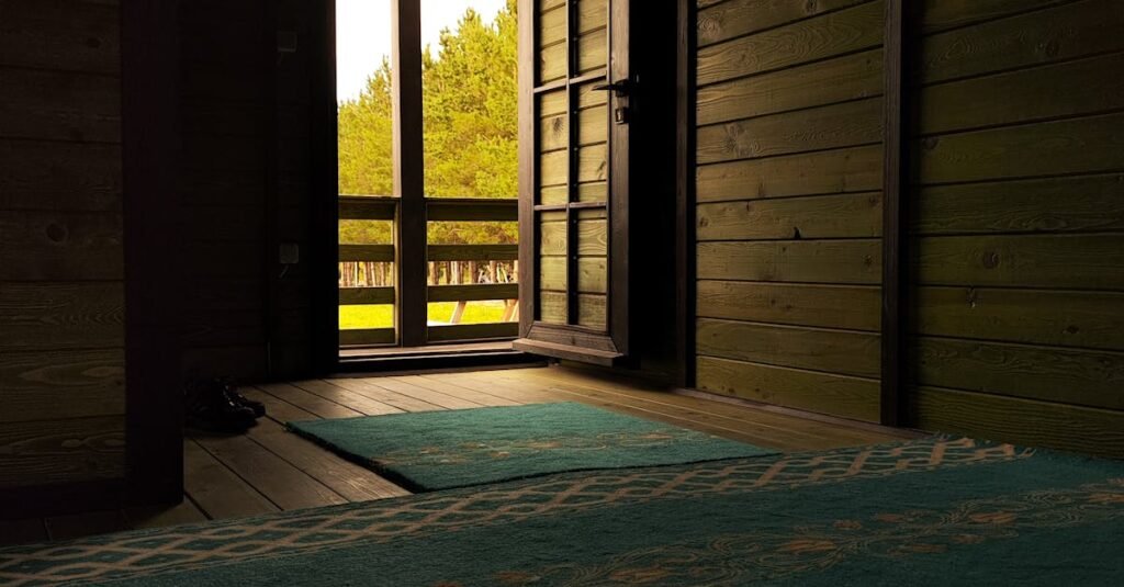 Dimly lit interior leading to open doorway with view of trees.