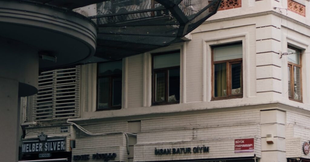 A yellow taxi parked at a historical street corner in Istanbul, showcasing classic architecture.