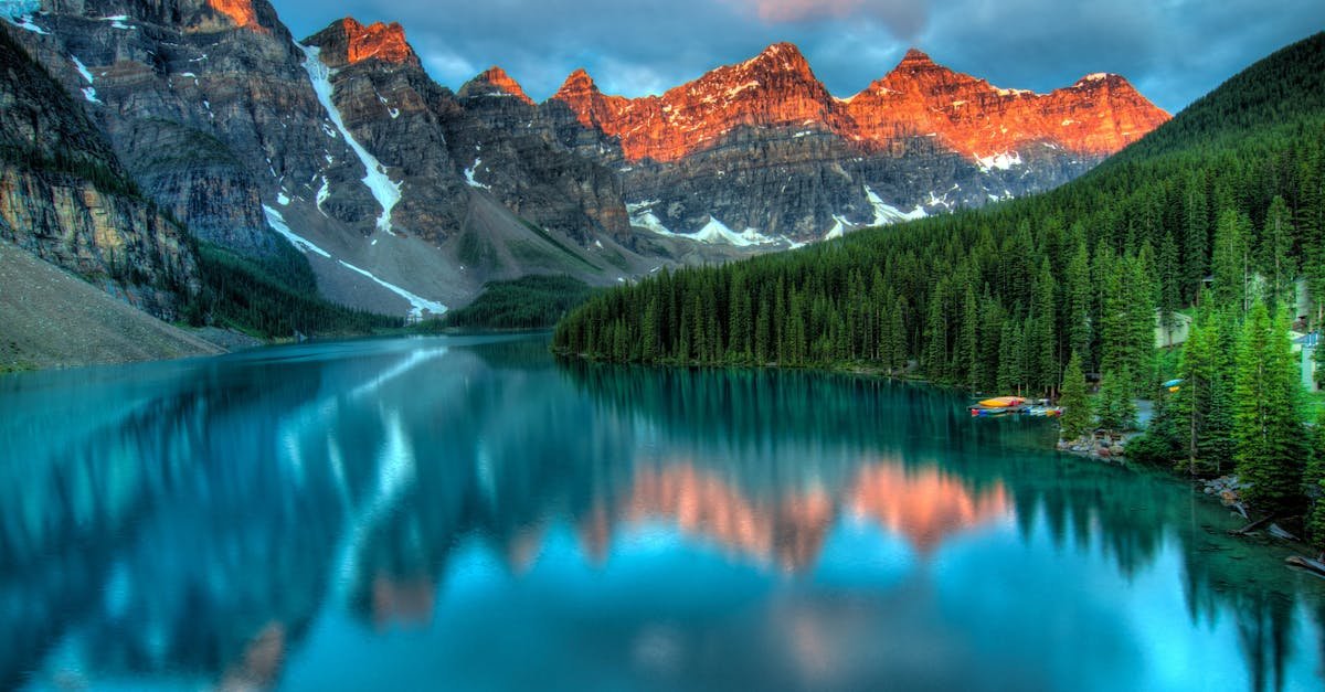 Capture the serene beauty of Moraine Lake with sunrise reflections in Banff National Park.