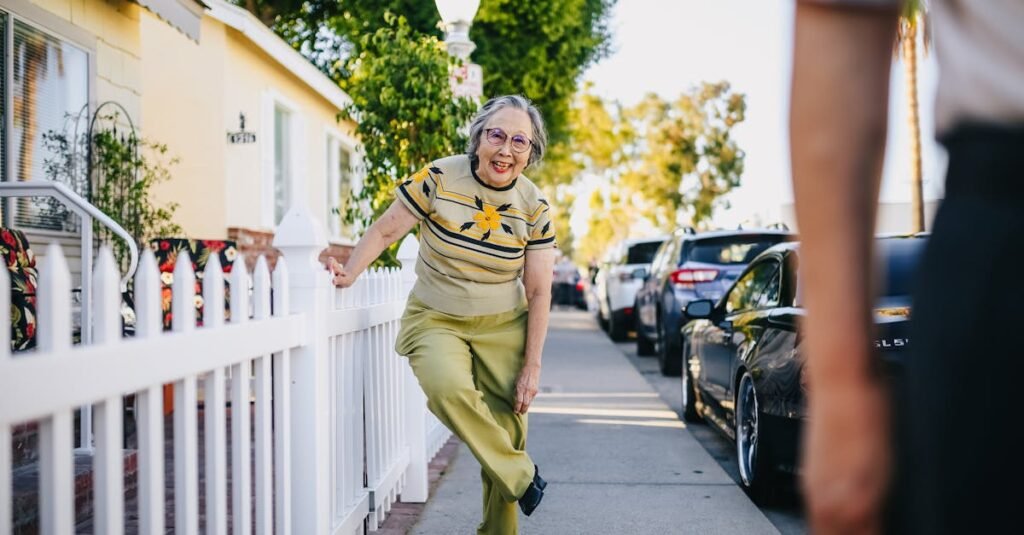Happy senior woman having fun on a sunny day in a suburban street.