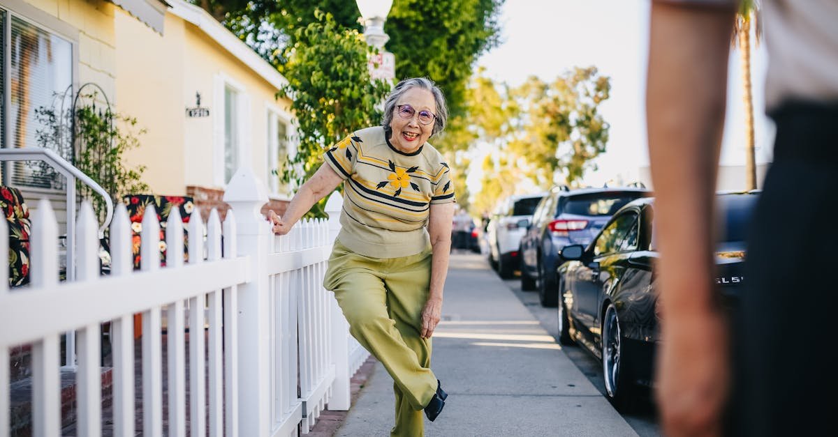 Happy senior woman having fun on a sunny day in a suburban street.