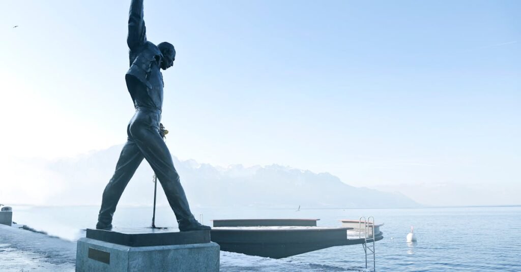 Iconic Freddie Mercury statue on Lake Geneva in Montreux, captured in a serene and foggy morning.
