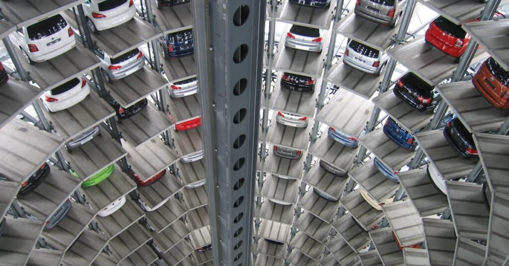 A vertical view of a spiral multi-storey car park filled with vehicles.
