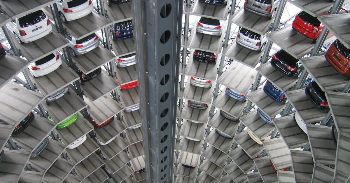 A vertical view of a spiral multi-storey car park filled with vehicles.