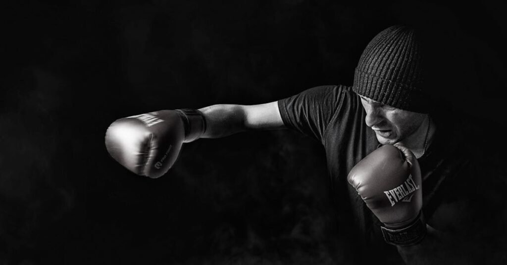 A powerful black and white image of a boxer throwing a punch, showcasing strength and focus.