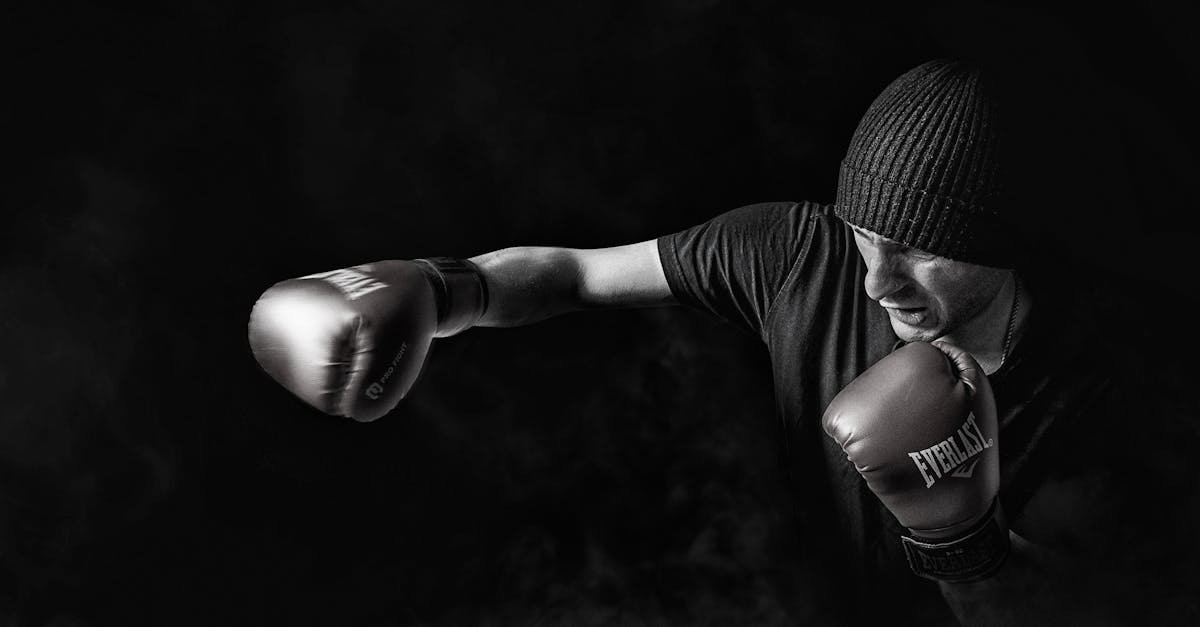 A powerful black and white image of a boxer throwing a punch, showcasing strength and focus.