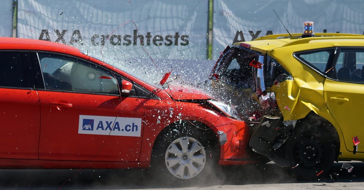 Red and yellow cars shown in a head-on collision during a crash test for safety evaluation.