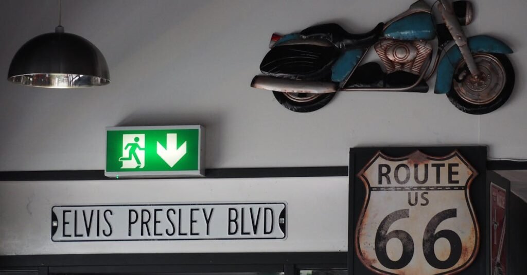 A retro interior decor featuring Elvis Presley Blvd sign, Route 66 sign, and a vintage motorcycle on a wall.