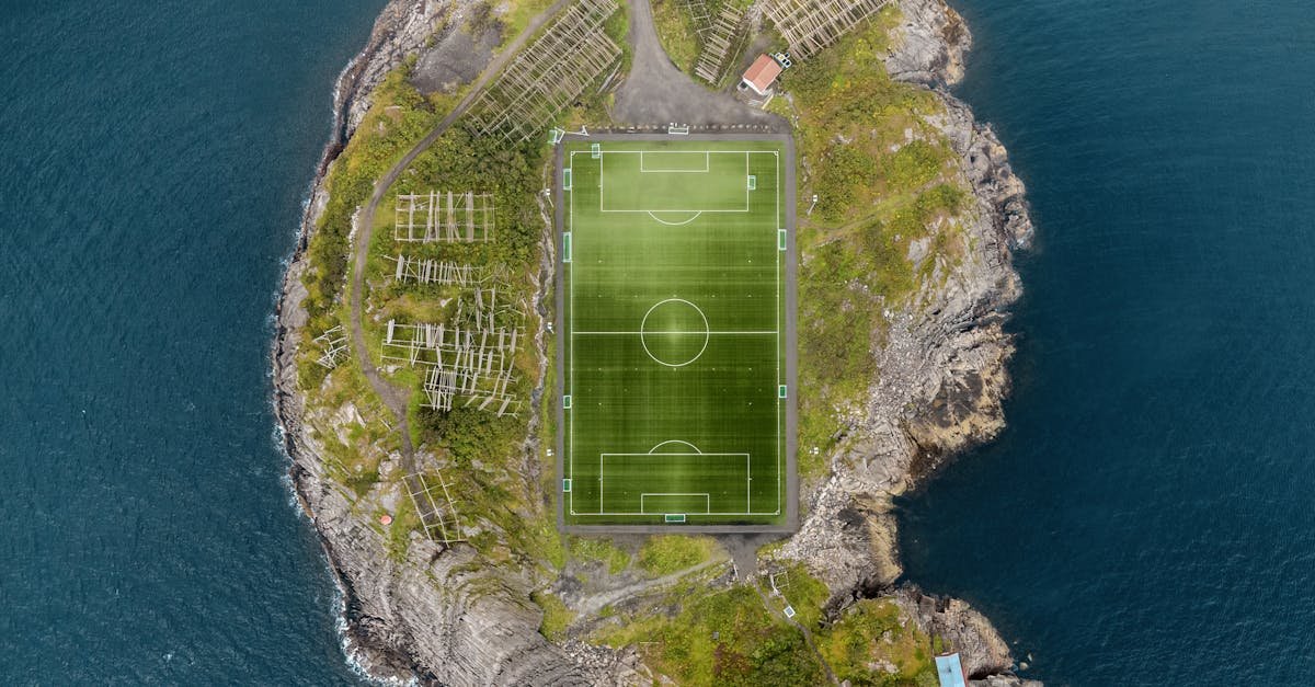 Stunning aerial view of the Henningsvær soccer field surrounded by the sea in Norway.
