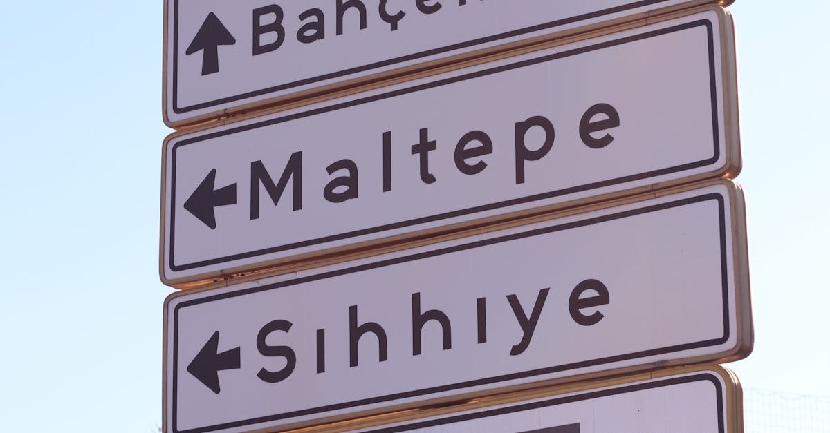 Road sign in Ankara pointing to Anıtkabir and various districts. Clear sky background.