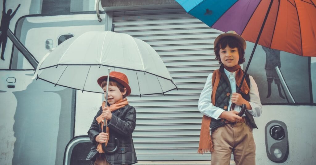 Two stylishly dressed boys holding colorful umbrellas, enjoying a rainy day outdoors.