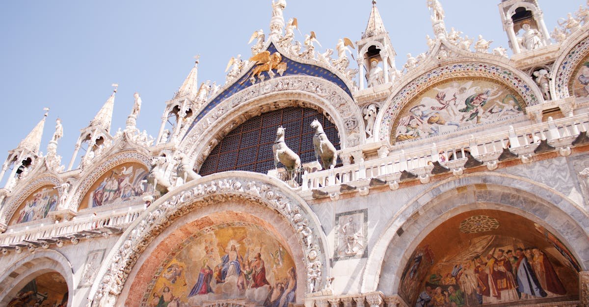 A detailed view of the ornate facade of St Mark's Basilica in Venice, illustrating its religious and architectural significance.
