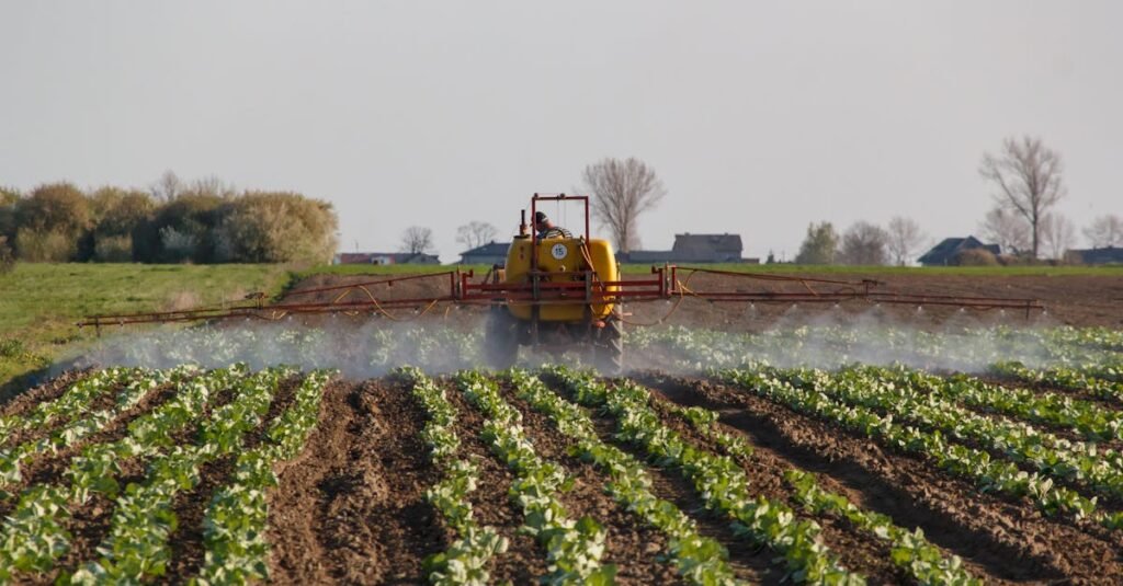 Tractor spraying a vibrant farm field. Capturing modern agriculture in action.