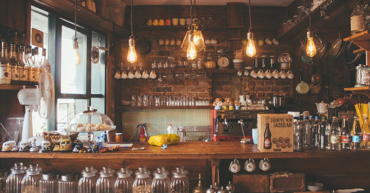 A cozy cafe with rustic decor, pendant lights, and glass jars creates a vintage ambiance.