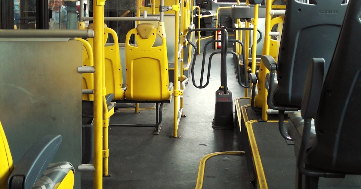 An empty bus with yellow seats and handrails in São Paulo, highlighting urban transportation.