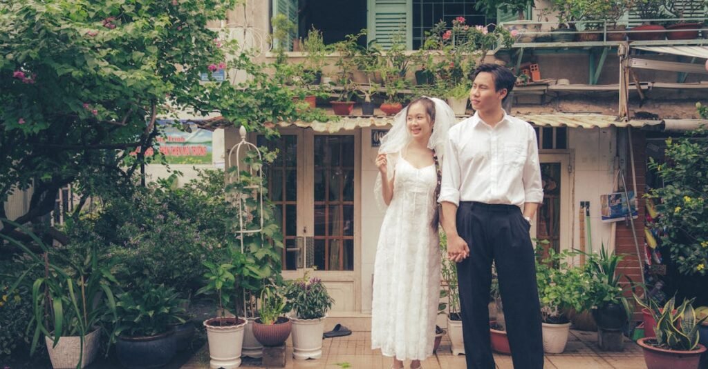 Joyful newlywed couple stands hand in hand in a lush garden, embodying love and happiness.
