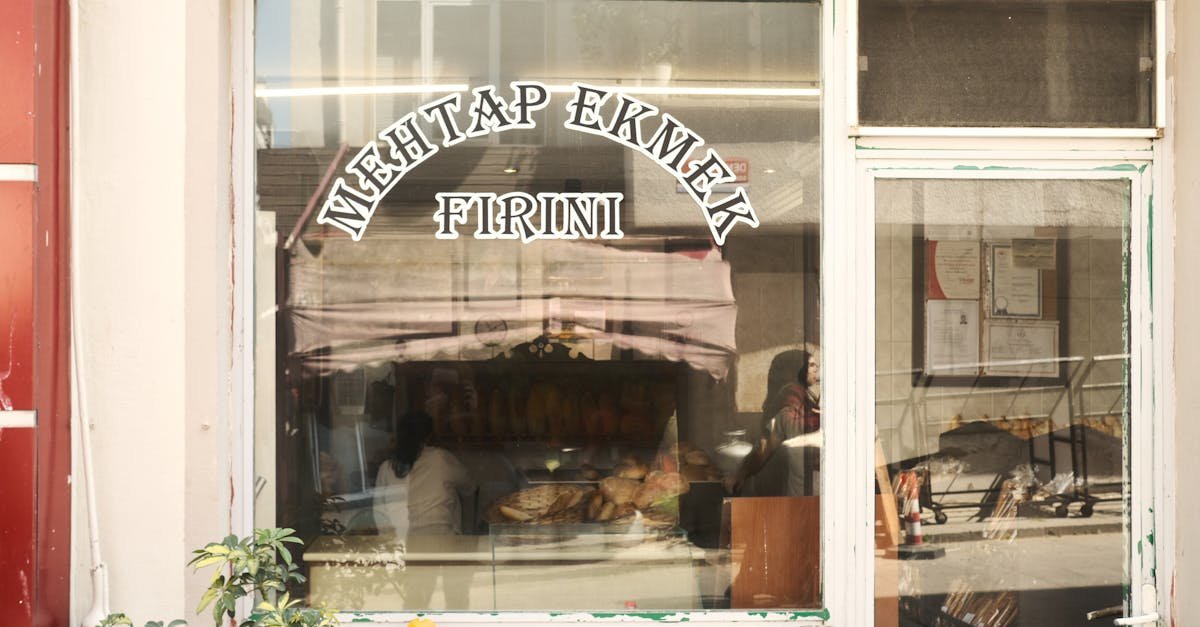A charming view of a traditional bakery storefront with fresh bread in the window.