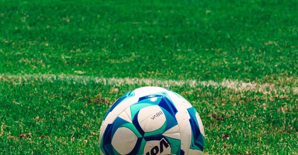 Vibrant soccer ball on a green field in Tlaxcala, Mexico, perfect for sports enthusiasts.