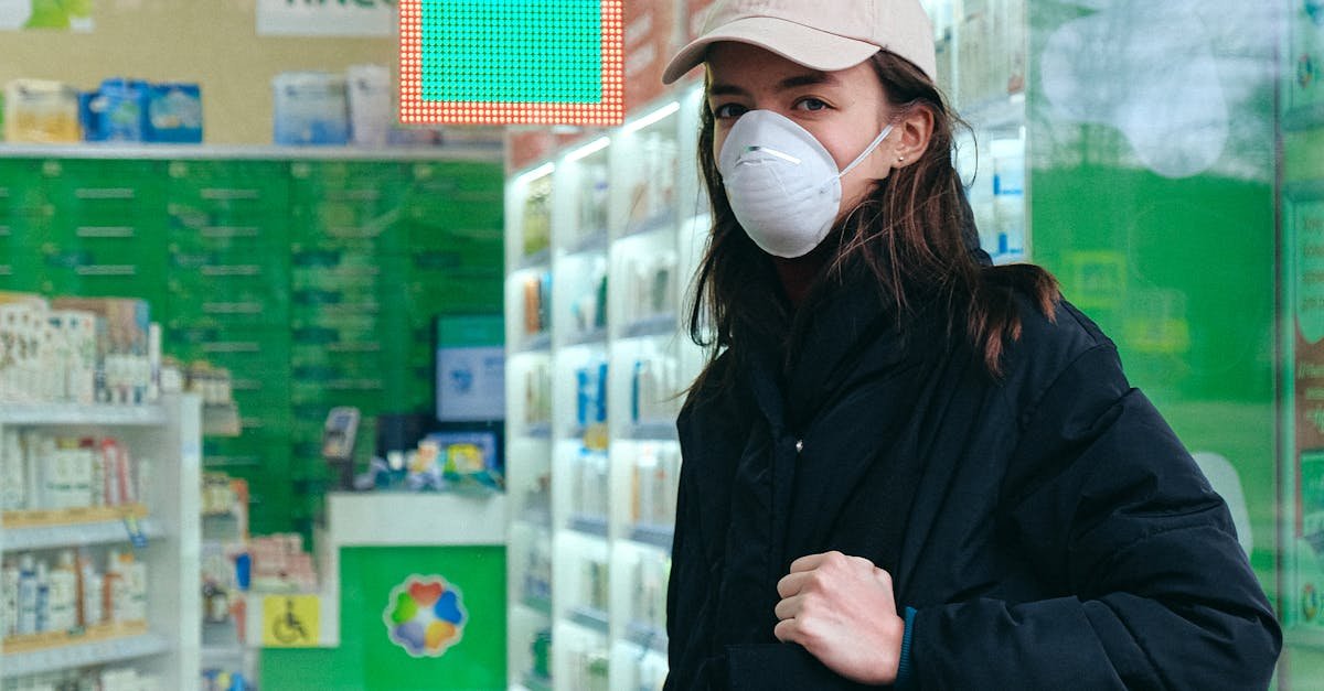 Woman in mask outside a pharmacy, with a bag and protective face mask, emphasizing health and safety.
