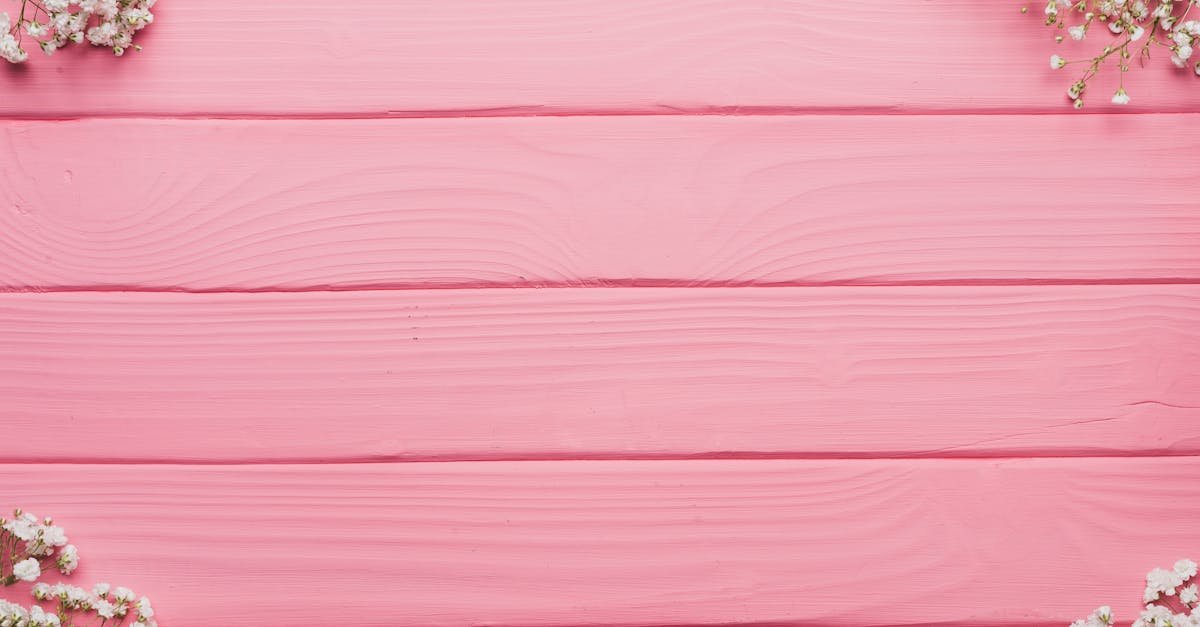 Aesthetic pink wooden background with white baby's breath flowers, ideal for weddings and events.