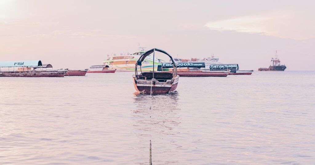 Tranquil view of boats floating on calm waters during sunset in Zanzibar, Tanzania.