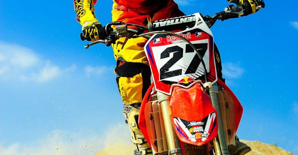 Motocross rider speeding on dirt track, showcasing skill and adrenaline.