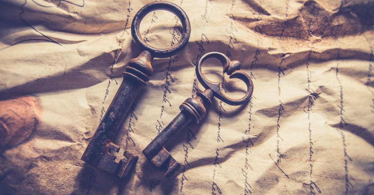Vintage iron keys resting on crumpled, handwritten paper with a rustic texture.