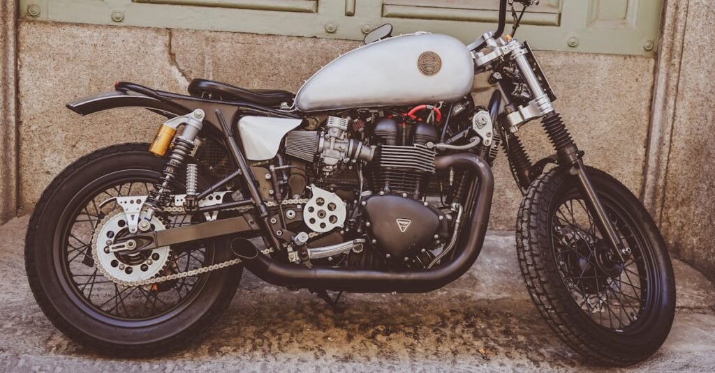 Classic motorcycle parked against a grunge wall, showcasing its sleek vintage design.