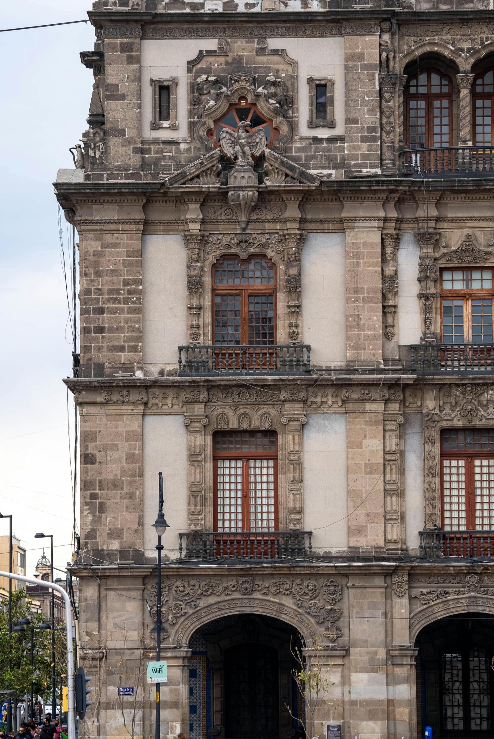 Close-up of a historic facade in Mexico City showcasing Gothic Revival architectural elements.