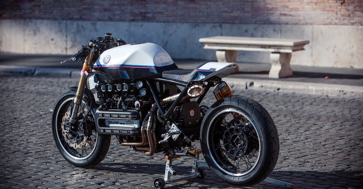 Classic vintage cafe racer motorcycle parked on cobblestone street, Rome, Italy.