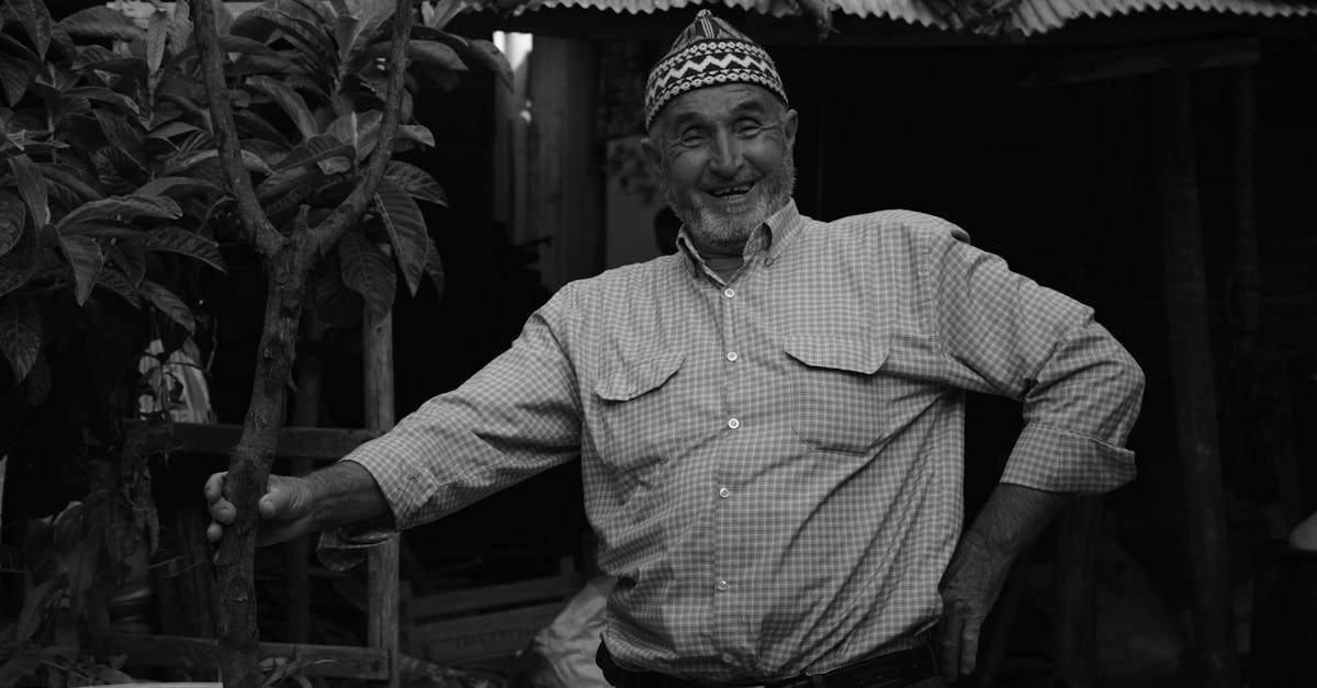 Elderly man smiling warmly while posing outdoors in Yenice, Manisa, Türkiye.