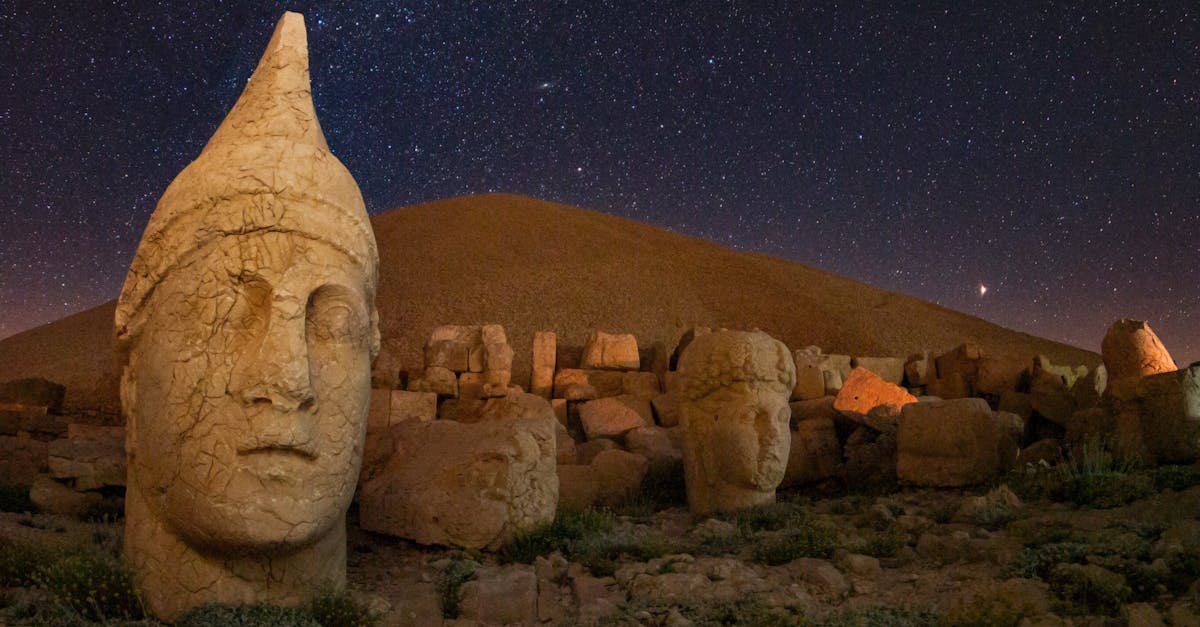 Captivating view of ancient statues on Mount Nemrut under a starry night in Adıyaman, Turkey.
