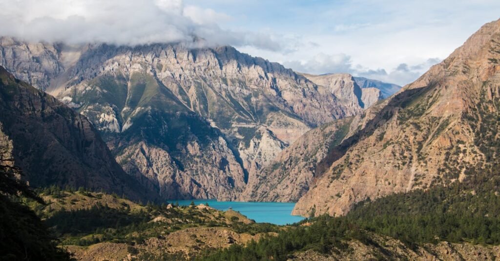 Breathtaking view of Shey Phoksundo Lake surrounded by majestic mountains in Nepal.