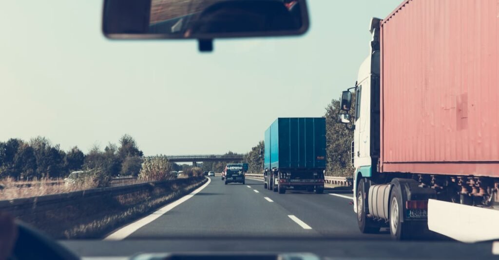 View through rearview mirror of trucks on a German highway, driving towards Bamberg.