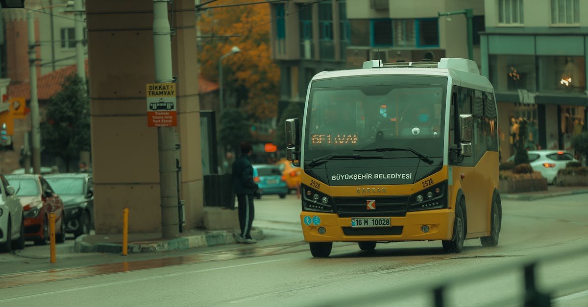 Yellow minibus operates on a rainy day in Bursa, capturing urban life in Turkey.