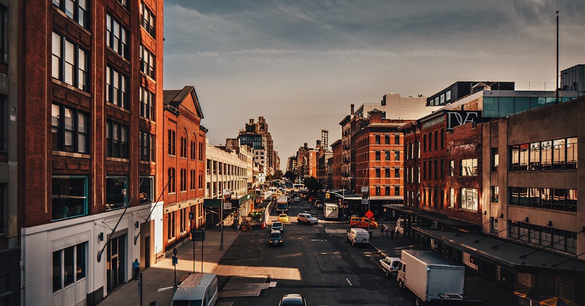 Sunny day in a bustling city street lined with historic buildings and vehicles.