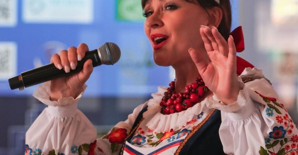 Woman performing in traditional Russian attire with microphone indoors.