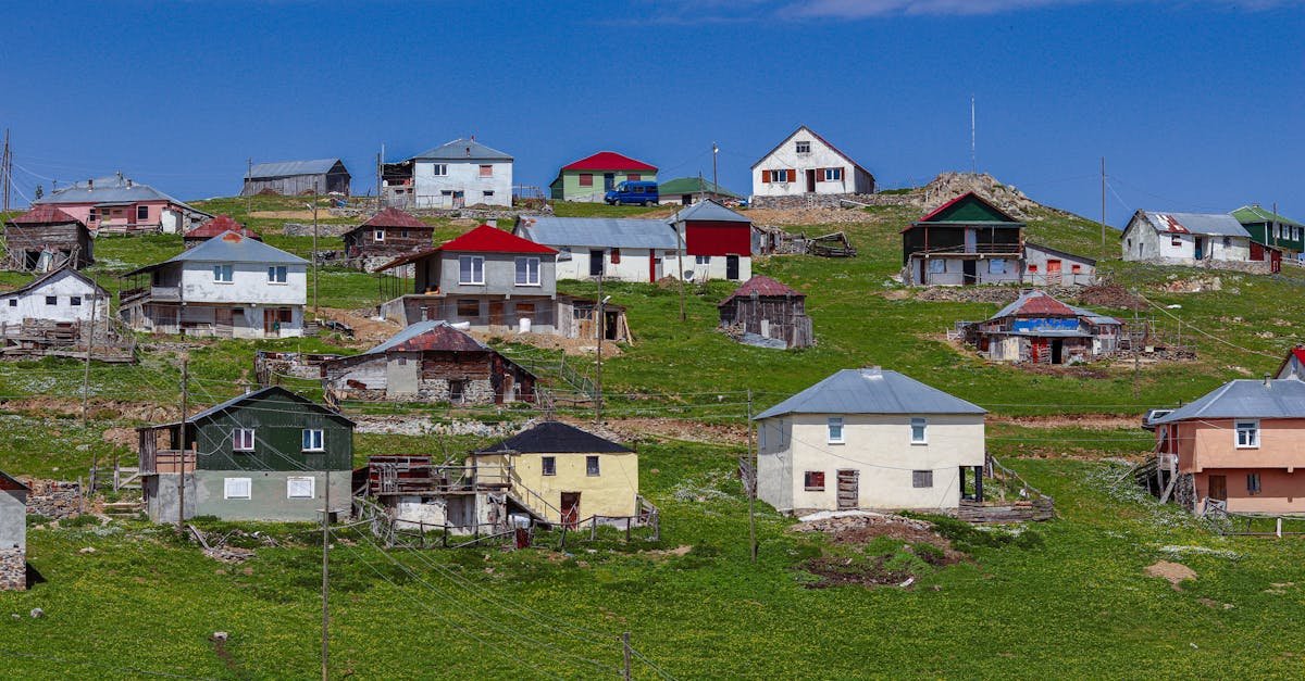 Scenic view of traditional houses on lush green hills in Gümüşhane, Türkiye.