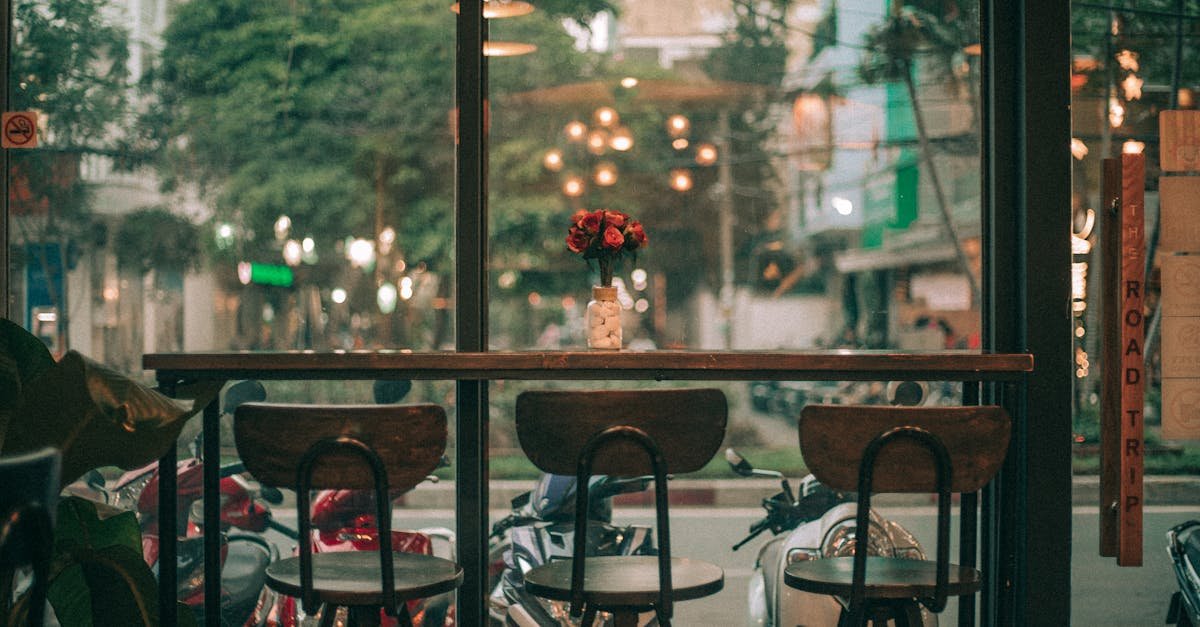 A cozy café in Ho Chi Minh City featuring a view of bustling streets with scooters.