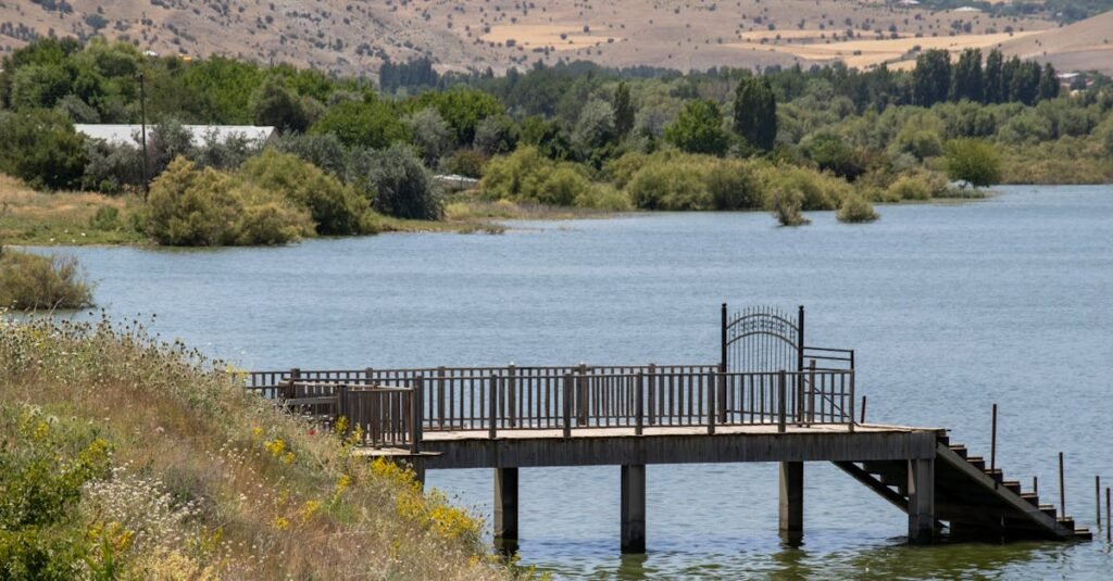 Serene landscape with a wooden pier extending over a tranquil lake in Elazığ, Türkiye.