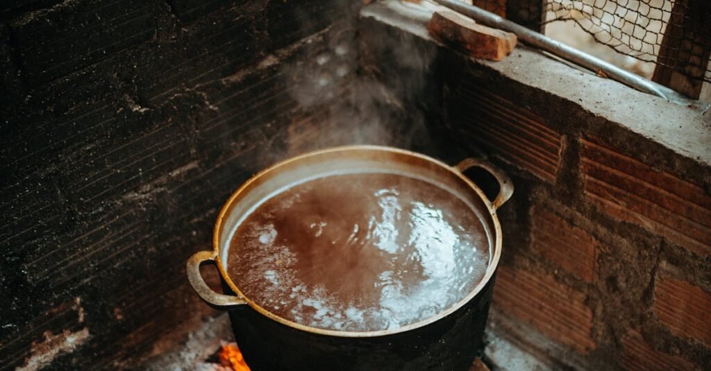 A steaming pot on an open fire in a traditional Vietnamese kitchen.