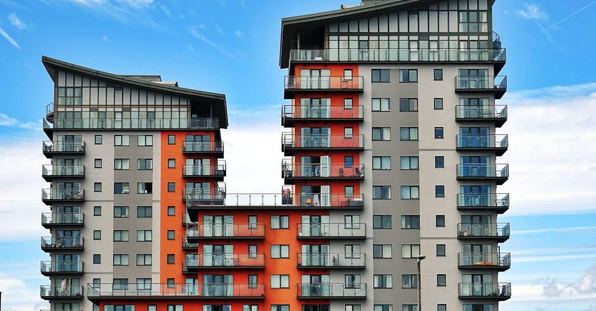 Modern high-rise apartment buildings with unique architecture under a vibrant blue sky.
